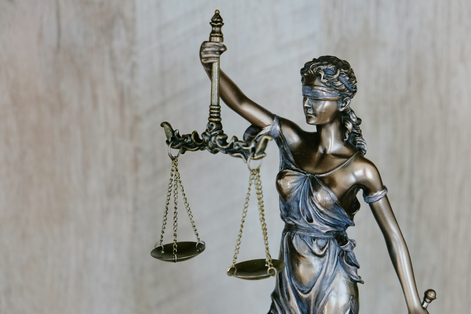 Law books and a gavel on a wooden desk, suggesting careful legal research